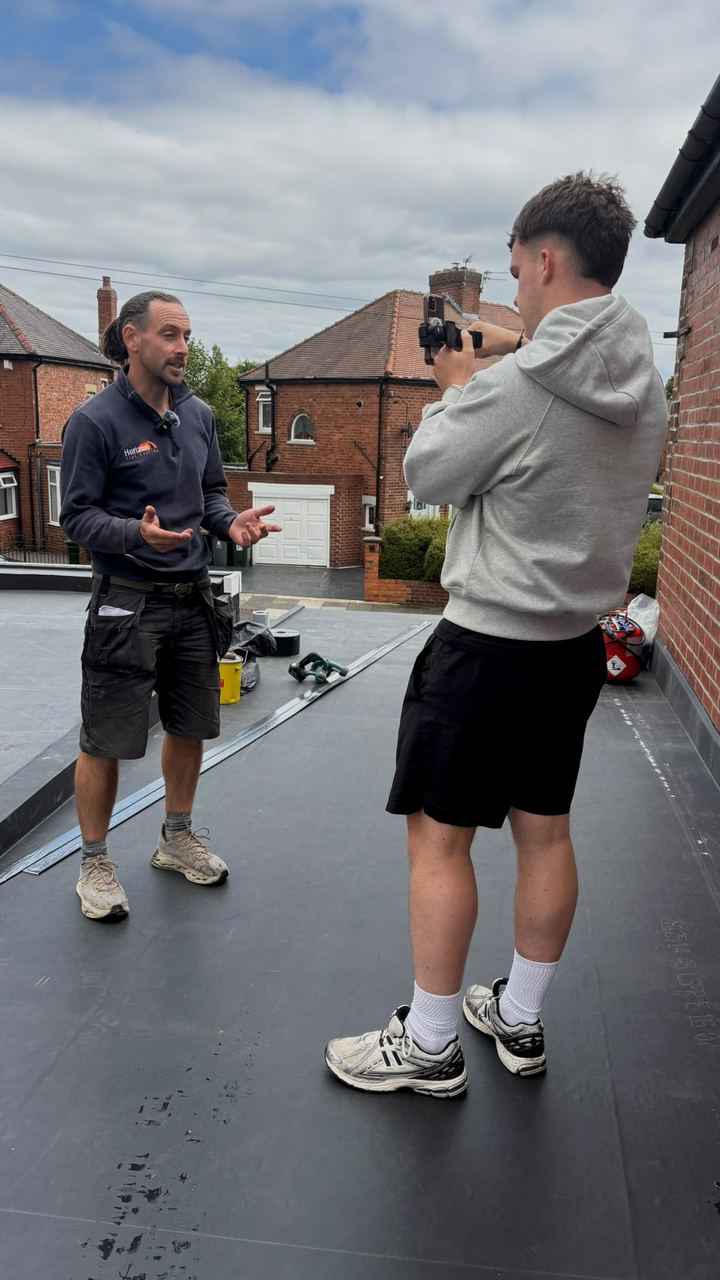 Pete being filmed on a flat roof
