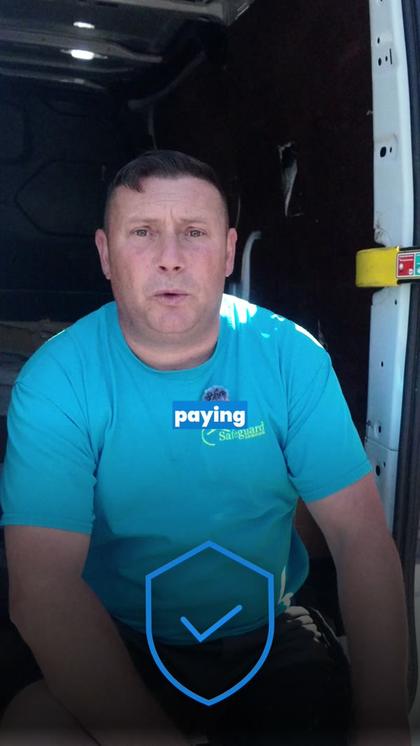 Ad still: roofer speaking from his van